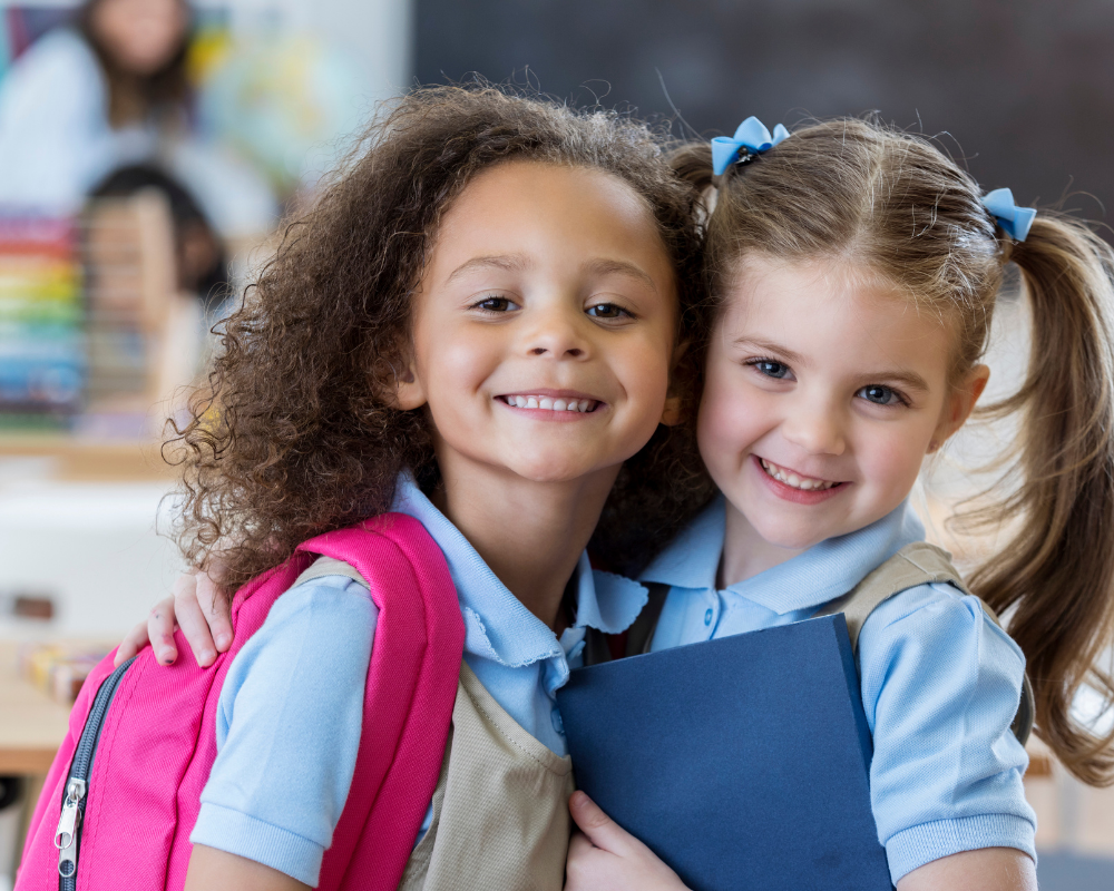 Two smiling girls in uniform