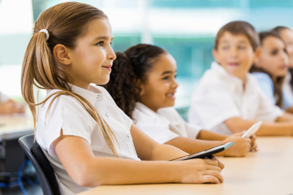 Smiling Catholic School Kids in Classroom