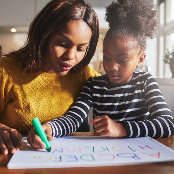 Mom helping daughter with schoolwork