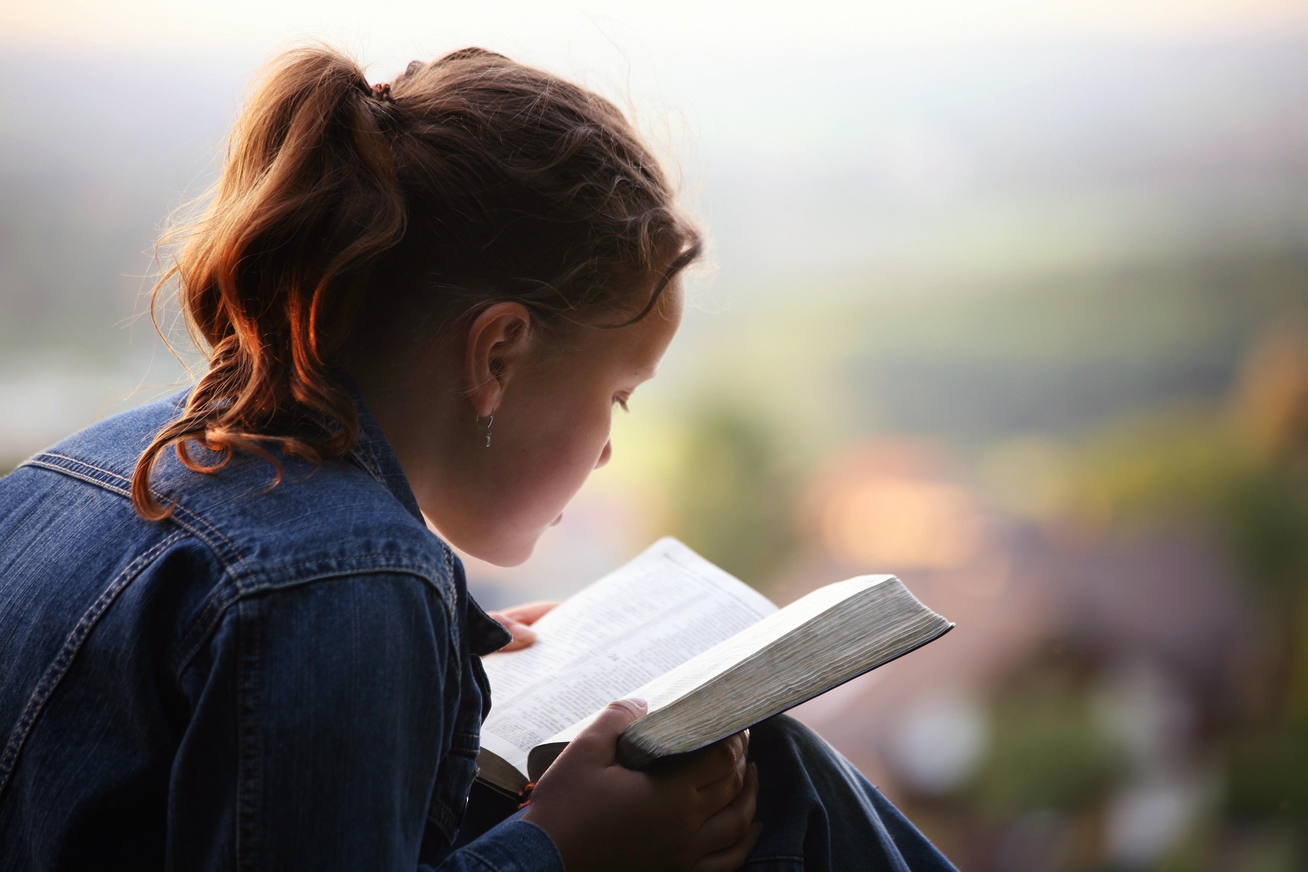 Middle school girl reading the Bible